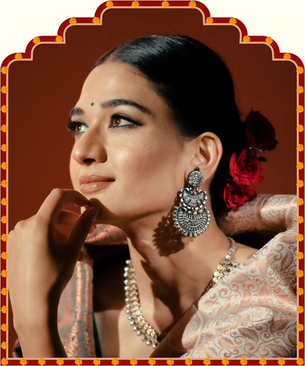Woman in traditional attire with jewelry and a decorative frame