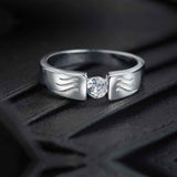 This sterling silver band features a unique wave design engraved with sparkling round zirconia, making it a stylish and versatile accessory for everyday wear. Crafted with a rhodium finish, it is a thoughtful gift option for men.