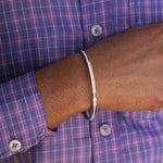 This White Grace Silver Kada for Men is expertly crafted with pure silver and finished with rhodium for a sleek and polished look. The enamel detail adds a touch of sophistication. Elevate your style with this high-quality, statement accessory that exudes confidence and refinement.