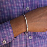 This White Grace Silver Kada for Men is expertly crafted with pure silver and finished with rhodium for a sleek and polished look. The enamel detail adds a touch of sophistication. Elevate your style with this high-quality, statement accessory that exudes confidence and refinement.