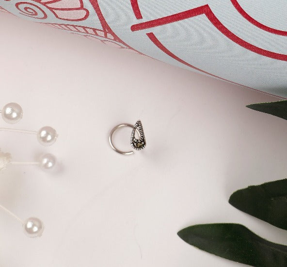 Sterling Silver wired nose pin with marcasite stone in paisley motif.