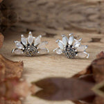 Introducing our White Magical Flower Sterling Silver Stud Earrings! These stunning earrings are crafted from high-quality sterling silver and feature a unique oxidized finish accented with moonstone and marcasite stones. The elegant half flower design adds a touch of whimsy to any outfit. Elevate your style with these enchanting earrings!