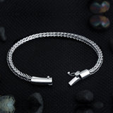 Close-up of Compassionate wide sterling silver men's bracelet showing barrel-style tube clasp and safety lock