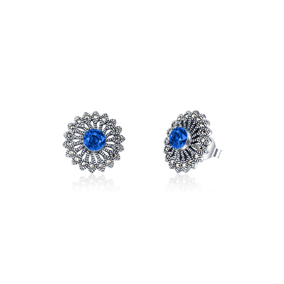 Introducing the Zainab Sterling Silver Studs, crafted with 925 sterling silver and an oxidised finish. Each stud is adorned with marcasite and a stunning blue zirconia center, delivering a touch of elegance to any outfit. Elevate your style with these timeless studs.