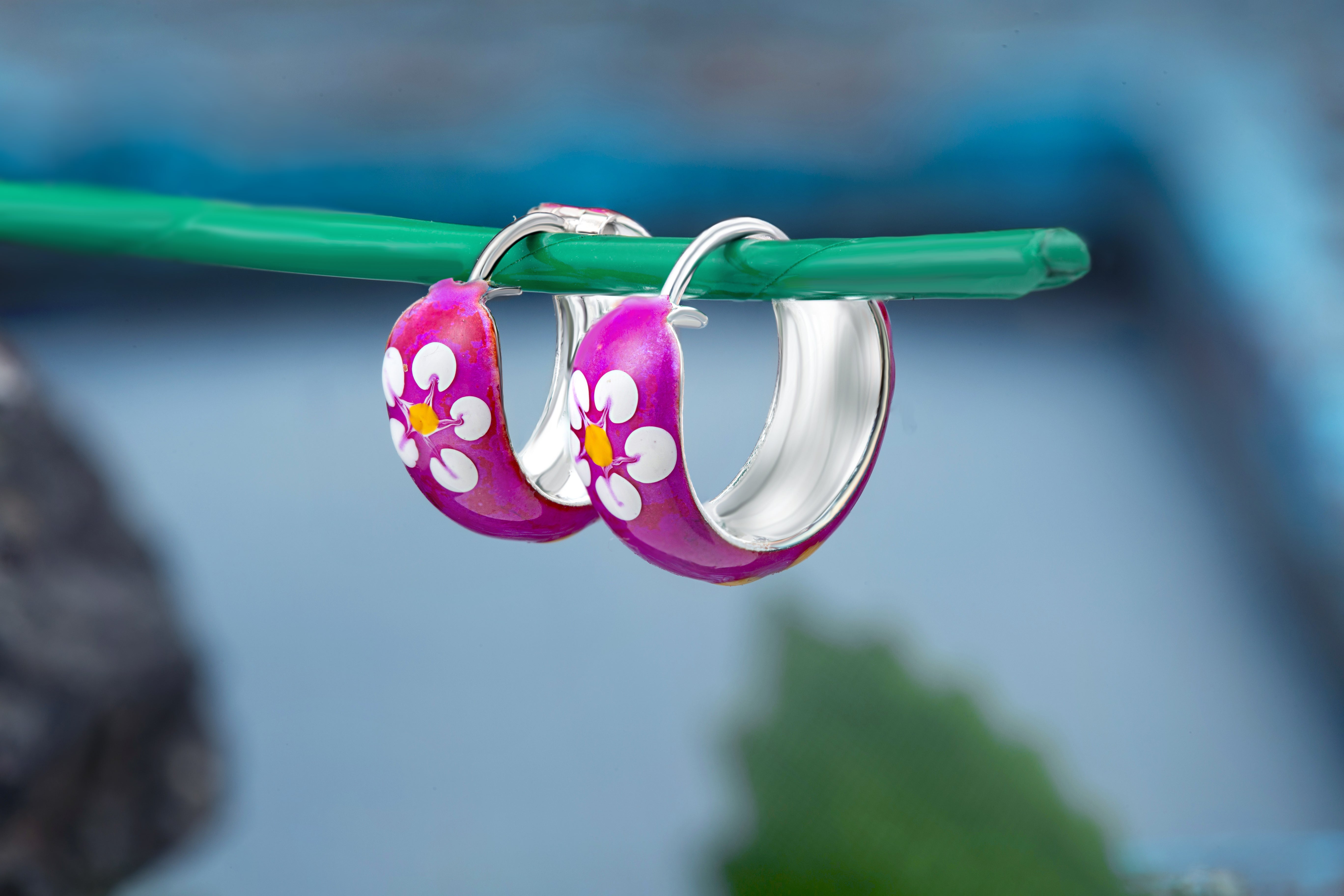 92.5 sterling silver hoops/baali with purple enamel and yellow printed flowers finished in silver and hinged back closure 