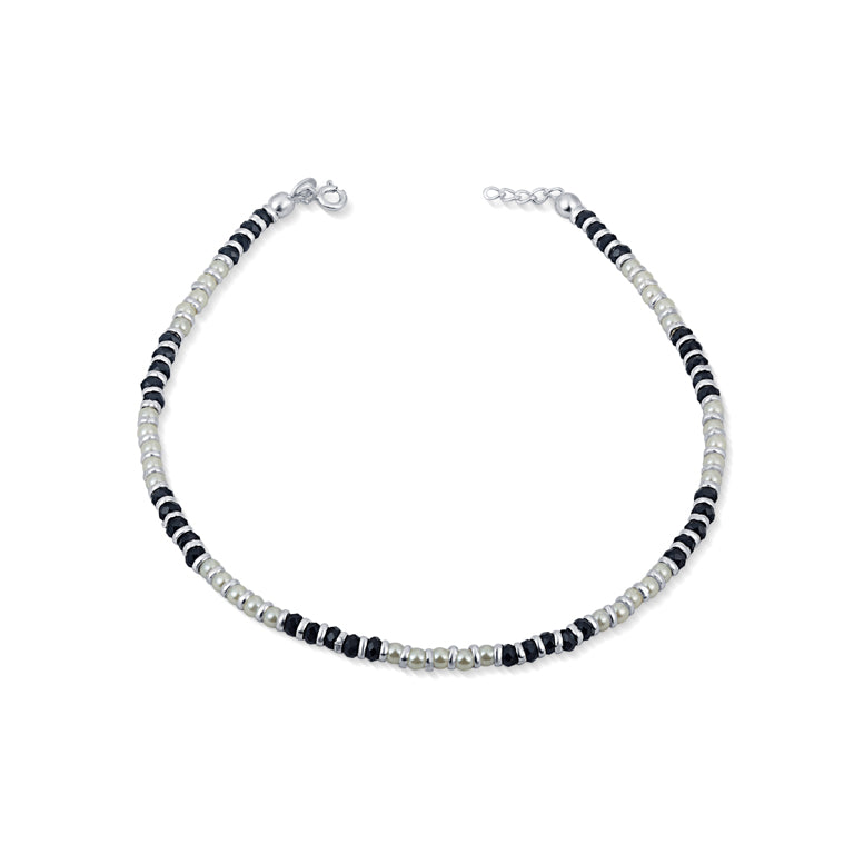 Stay protected with our sterling silver nazariya anklet for women. Featuring white and black beads, this anklet is not only stylish but also wards off the evil eye. Keep positive energy around you with this elegant accessory.