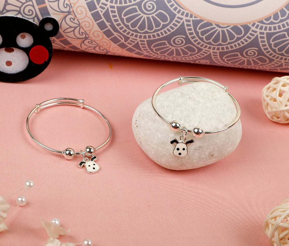 Welcome your little one to the world with our White Puppy Charms Baby Bangles. Crafted with Sterling Silver, these bangles feature a silver finish and a charming puppy charm with an enamel finish. Designed for comfortable wear for your baby. Show off your little one's style with these adorable bangles.