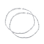 A pair of silver hook closure anklets for women.


