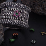 92.5 Sterling Silver Kada with floral patterns in antique finish studded with ruby and emerald
